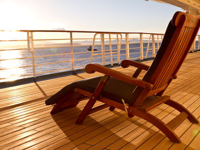 Wooden-lounge-chair-on-the-deck-of-a-cruise-ship-157558621_3867x2578